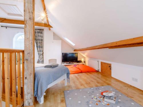 a attic bedroom with a bed and a television at 3 bed in Braunton 85884 in Barnstaple
