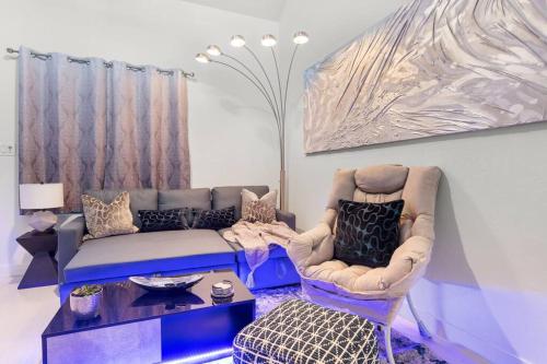 a living room with a couch and a table at The Hidden Gem, King bed & Swimming Pool! in Chandler