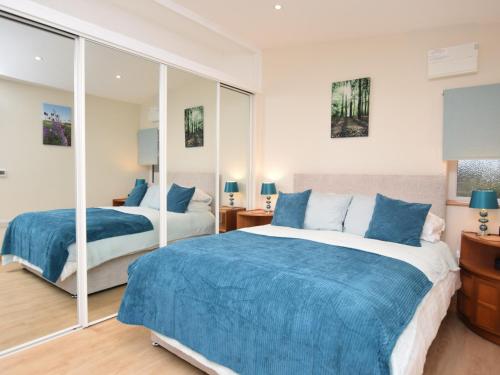 a bedroom with two beds and a mirror at 1 bed property in Sherborne 86426 in South Cadbury