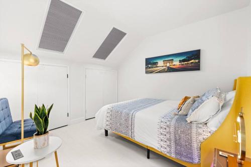 a white bedroom with a bed and a chair at The Hidden Gem, King bed & Swimming Pool! in Chandler