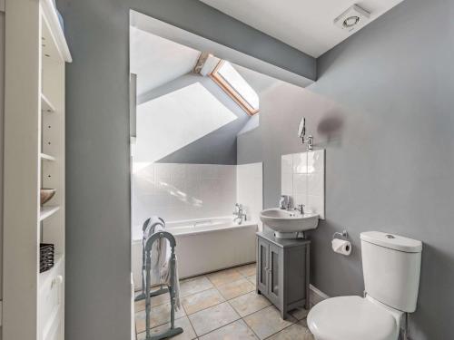 a bathroom with a toilet and a sink and a bath tub at 2 bed property in Ammanford 87025 in Llandybie