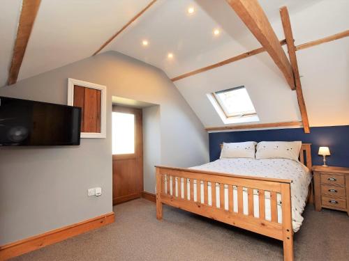 a bedroom with a bed and a flat screen tv at 2 bed property in Ammanford 87025 in Llandybie