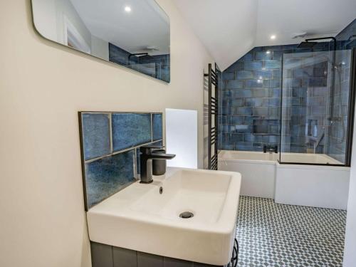 ein Badezimmer mit einem weißen Waschbecken und einer Dusche in der Unterkunft 3 bed in Llandysul 87071 in Pencader