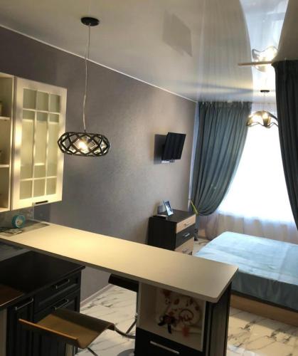 Zimmer mit einem Schreibtisch und einem Schlafzimmer mit einem Bett. in der Unterkunft VIP apart 525 in Tbilisi City