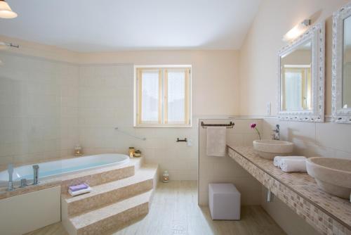 a bathroom with two sinks and a tub at Villa Aurora near Rovinj for 8 persons with sea view & whirlpool in Bale