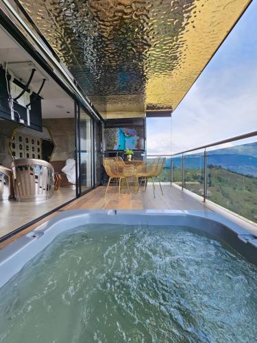 a jacuzzi tub in a house with a dining table at La casa en el aire in Medellín