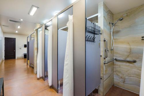 a row of stalls in a hallway with a shower at HTR Moab in Moab