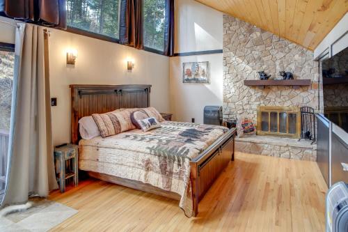 a bedroom with a bed and a stone wall at Ruidoso Cabin Retreat with Multi-Level Deck in Ruidoso