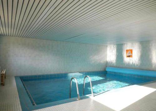 a large swimming pool with two faucets in a room at Haus Lucia in Schönwald