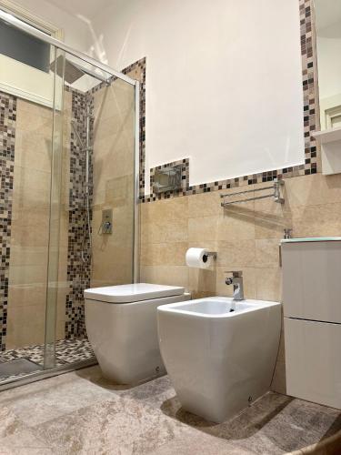 a bathroom with a toilet and a sink and a shower at Al Conservatorio Vecchio in Salerno