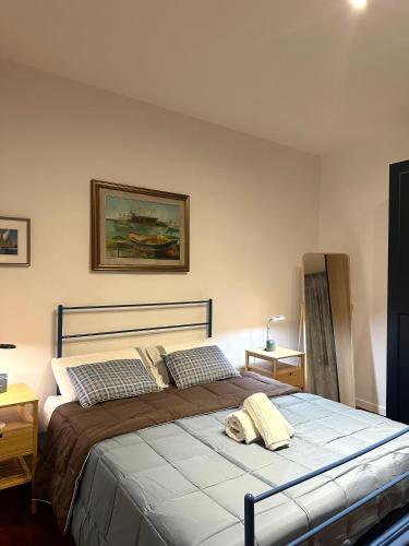 a bedroom with a large bed with two pillows at Al Conservatorio Vecchio in Salerno