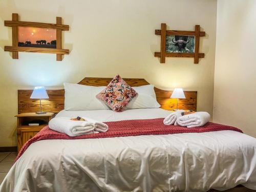 a bedroom with a bed with towels on it at Leribisi Lodge in Tierpoort