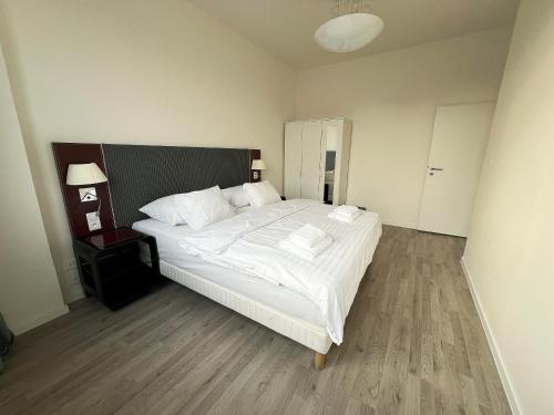 a bedroom with a large bed with white sheets and pillows at Holiday home Prague in Prague