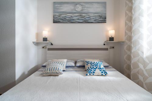 a bedroom with a bed with two pillows on it at Appartamento da Manzela 2 in Cala Gonone