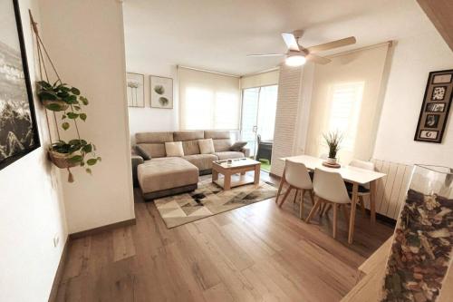 a living room with a couch and a table at SeaHomes Vacations - CORAL SUN in Fenals Beach in Lloret de Mar