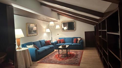 a living room with a blue couch and a table at Hotel Roma in Bologna