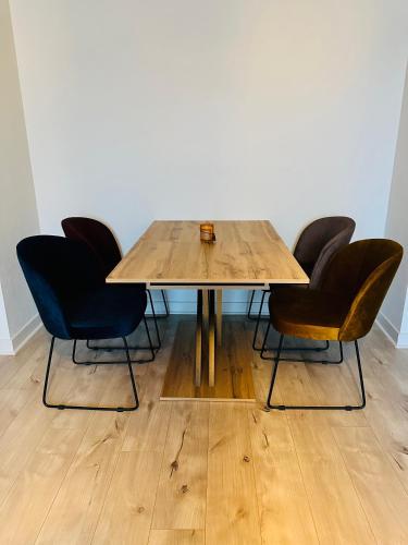 une table en bois avec quatre chaises autour dans l'établissement AVENUE DE CHAMPAGNE, à Épernay