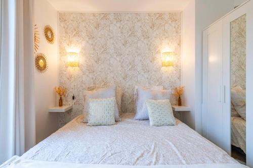a bedroom with a bed with blue and white pillows at Cosy place for 4 - Fairytale Factory in Bussy-Saint-Georges