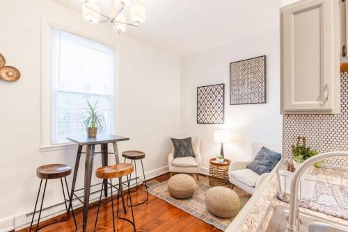 a white living room with a table and chairs at Stylish Flat in Walkable Downtown w Parking in Cincinnati