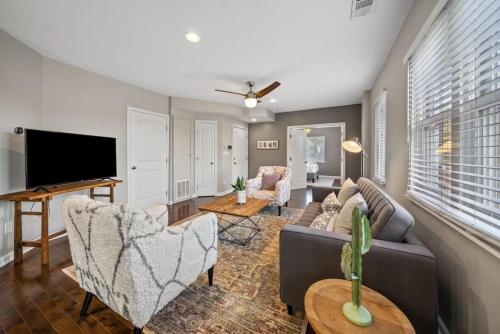 a living room with a couch and a tv at Classy 2BR Condo Near City Centre - OTR, UC, Zoo in Cincinnati