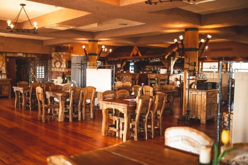 a restaurant with tables and chairs in a room at Hotel Rycerski in Czeladź