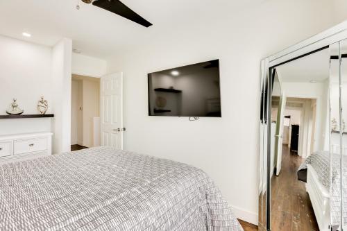 a white bedroom with a bed and a mirror at 7 Mi to State Farm Stadium Family Home with Pool in Glendale