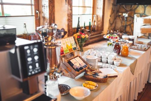 a long table with food and drinks on it at Hotel Rycerski in Czeladź