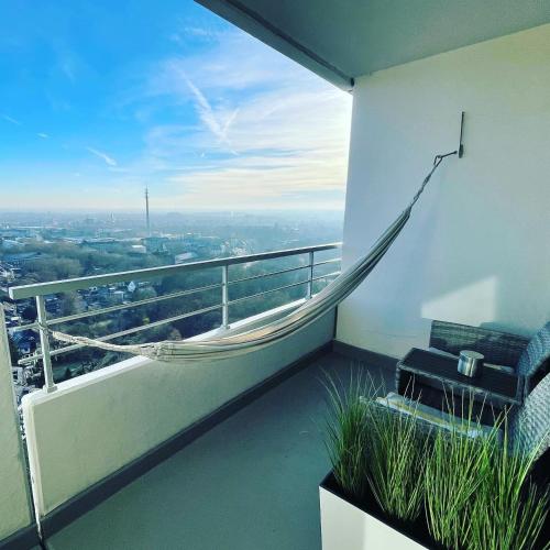 a balcony with a hammock on the side of a building at Themenpartment Penthouse in Gelsenkirchen