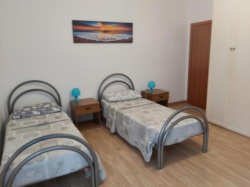 a room with two beds and two night stands at Appartamento Venezia in Marghera
