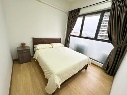 a bedroom with a bed and a large window at Sand Resort @ Country Garden Danga Bay in Johor Bahru