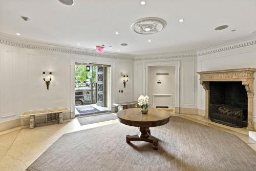 a living room with a table and a fireplace at Placemakr Dupont Circle in Washington