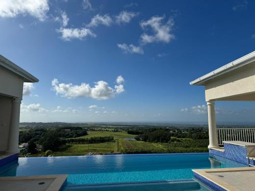 a swimming pool with a view from a house at Amaro Villas Barbados Feel like when you're home in Saint Thomas