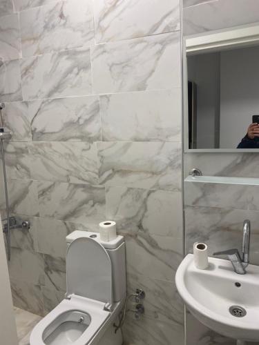 a bathroom with a toilet and a sink and a mirror at yenikapı hotel in Istanbul