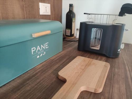 a bottle of wine next to a cooler and a wooden table at B&B La casa di Anna in Bucchianico