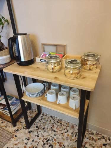 a wooden table with jars and dishes on it at B&B La casa di Anna in Bucchianico