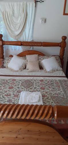 a bedroom with two beds with white towels on them at Happy Grove Lodge 