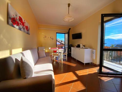 a living room with a white couch and a table at Sunrise Inn & Spa in Pessinetto