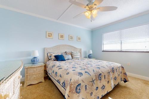 a bedroom with a bed and a ceiling fan at Golden Sands 613 in Ocean City