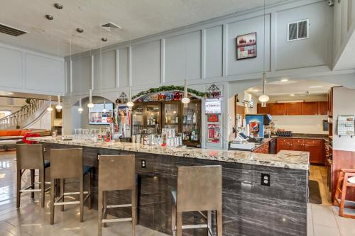 a bar in a restaurant with bar stools at Radisson Hotel Salt Lake City Airport in Salt Lake City