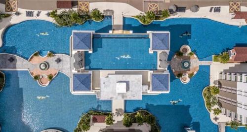 an aerial view of a swimming pool next to a body of water at Arcadia Beach Continental by Saowanee in Pattaya South
