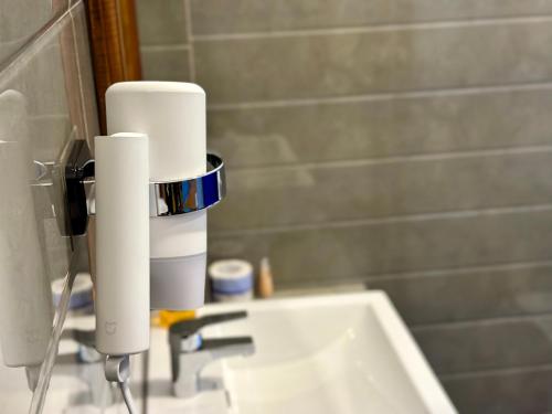 a bathroom sink with a roll of toilet paper at Nature House in Udawalawe