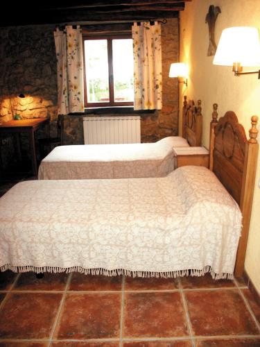 a bedroom with two beds and a window at Aristieta in Ajangiz