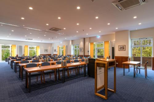 a conference room with desks and chairs in it at Hotel Waldesrand in Herford
