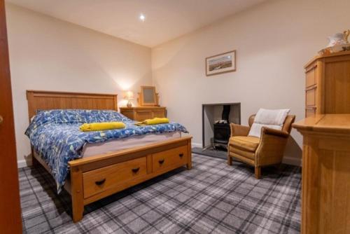 a bedroom with a bed and a chair at 176 Marrell in Helmsdale