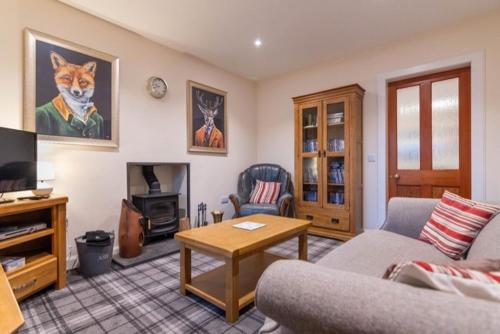 a living room with a couch and a table at 176 Marrell in Helmsdale
