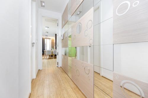 a hallway with white walls and wooden floors at LA CATOLICA GUEST HOUSE in Granada