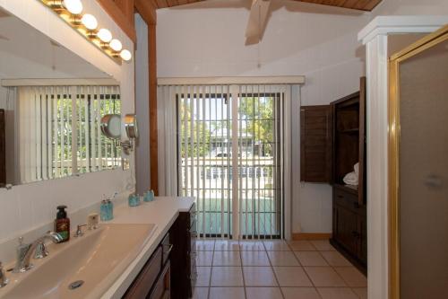 a bathroom with a sink and a mirror at Bay Therapy in Key Largo