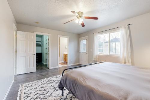 a bedroom with a bed and a ceiling fan at Carlton Cottage in Meridian