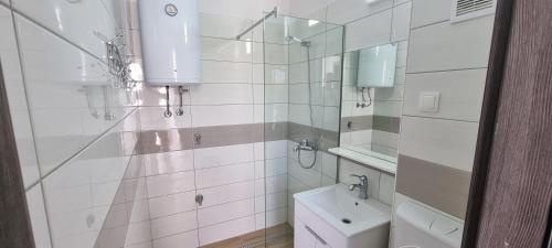 a white bathroom with a toilet and a sink at Mirjana Gajac in Gajac