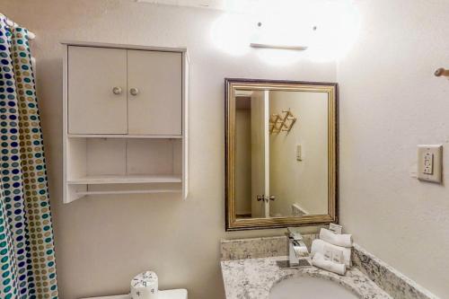 a bathroom with a sink and a mirror at Gulfview I #201 in South Padre Island